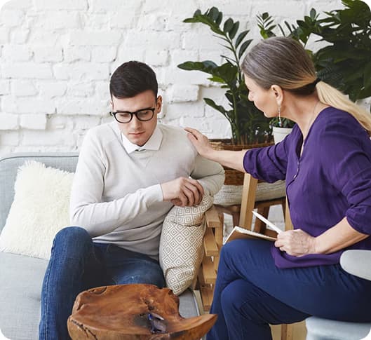 Mental health professional with patient at home